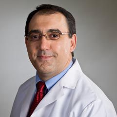 Alexander Hoghooghi, MD, DDS professional headshot, a middle-aged man with dark hair